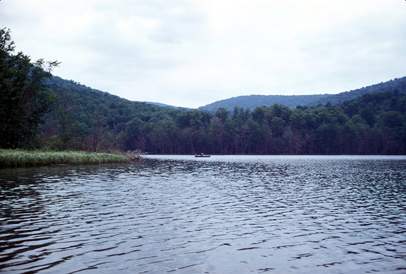 A lone fisherman enjoys a quiet moment out on the lake (1969)